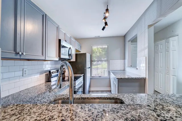 a kitchen with a refrigerator and cabinets