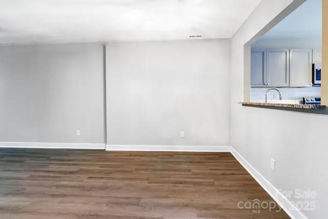 a view of a room with wooden floor