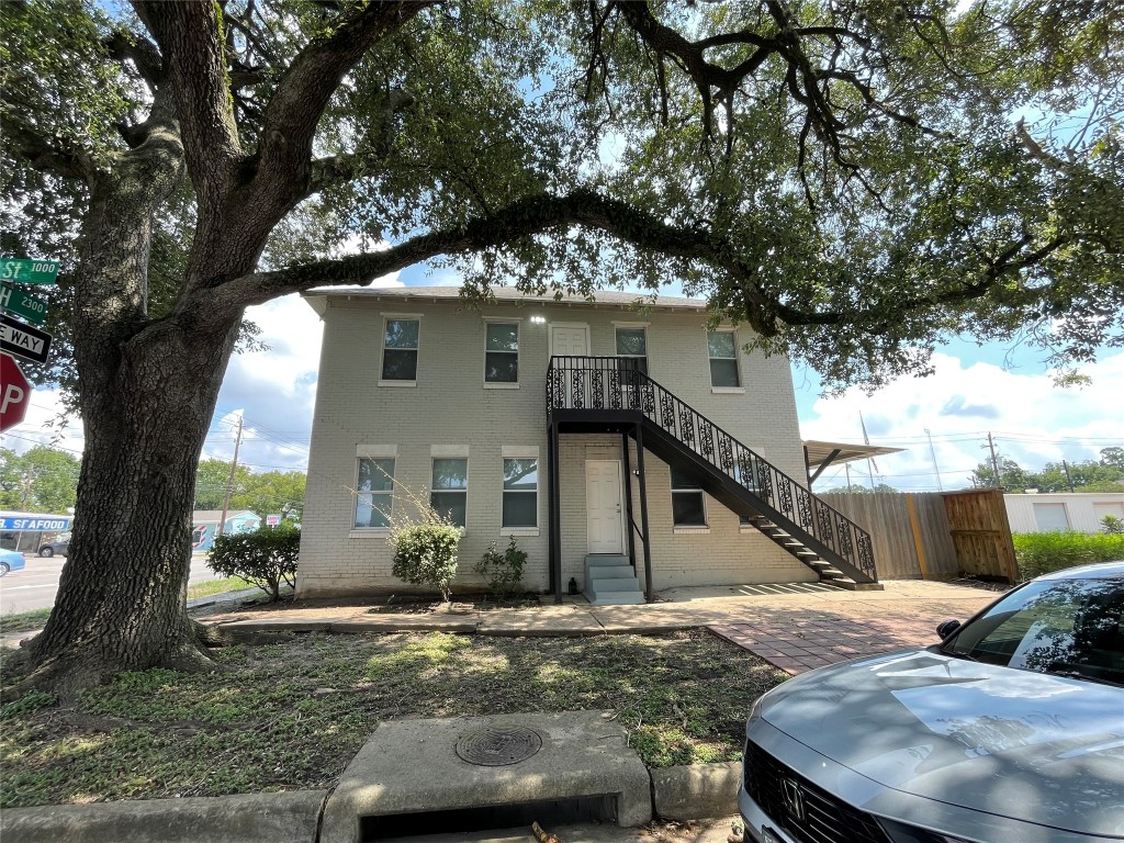 2302 Avenue H, Unit 14 Rosenberg, TX 77471 - Photo 14 of 15 a front view of a house with a yard