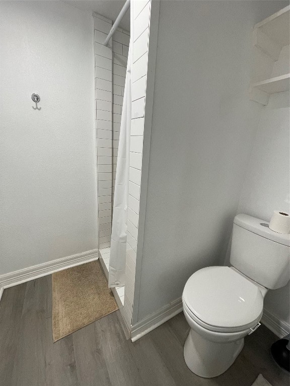 2302 Avenue H, Unit 14 Rosenberg, TX 77471 - Photo 8 of 15 a white toilet sitting next to a shower