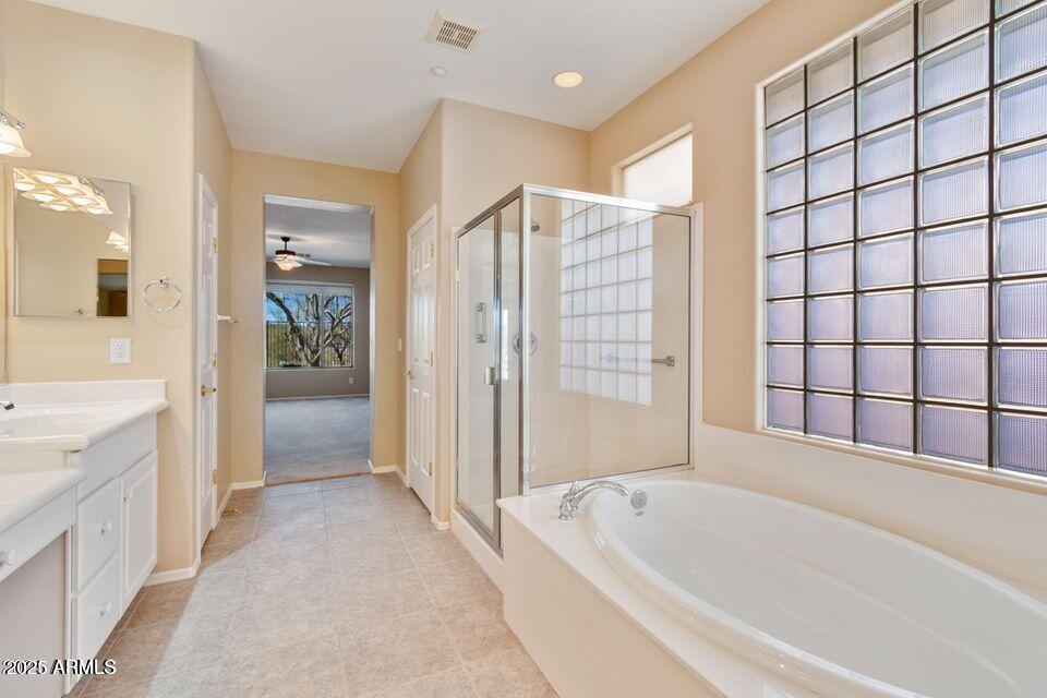 41526 North Cedar Chase Road Anthem, AZ 85086 - Photo 12 of 14 a spacious bathroom with a bathtub and a shower