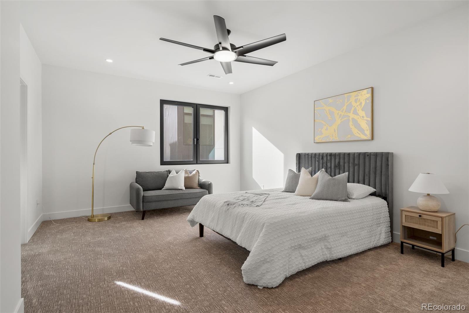 1256 Yates Street Denver, CO 80204 - Photo 15 of 26 a bedroom with a bed couch and window