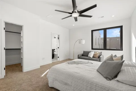 a bedroom with a large bed and a chandelier