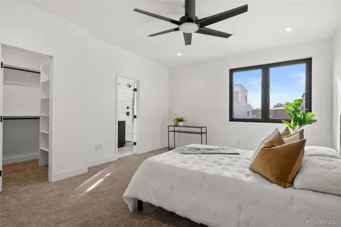 a bedroom with a large bed and a chandelier