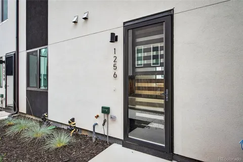 a bathroom with a granite countertop shower and a sink