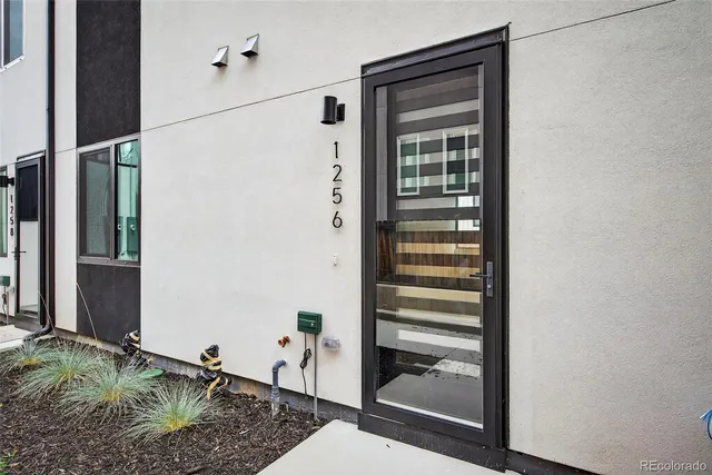 a bathroom with a granite countertop shower and a sink