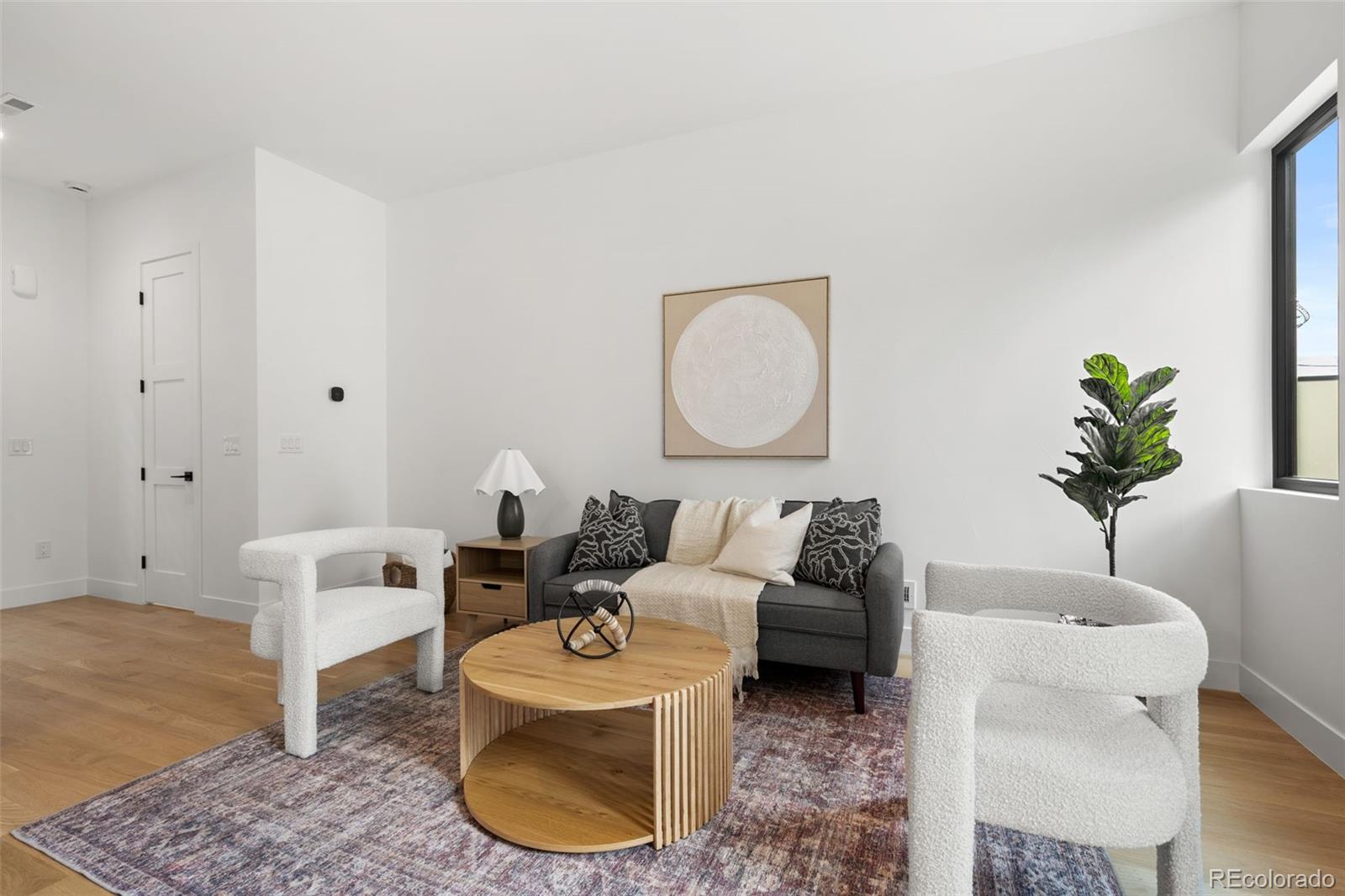 1256 Yates Street Denver, CO 80204 - Photo 5 of 26 a living room with furniture a couch and a potted plant