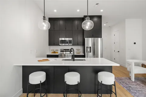 a large kitchen with a table and chairs