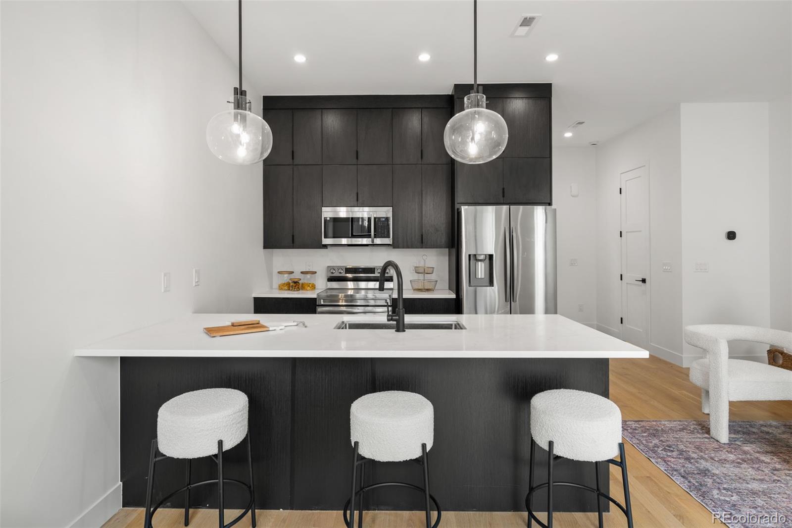 1256 Yates Street Denver, CO 80204 - Photo 9 of 26 a large kitchen with a table and chairs