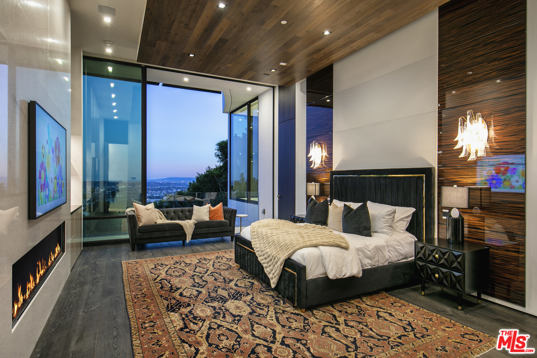 9364 Beverlycrest Drive Beverly Hills, CA 90210 - Photo 11 of 18 a bedroom with a large bed and a couch