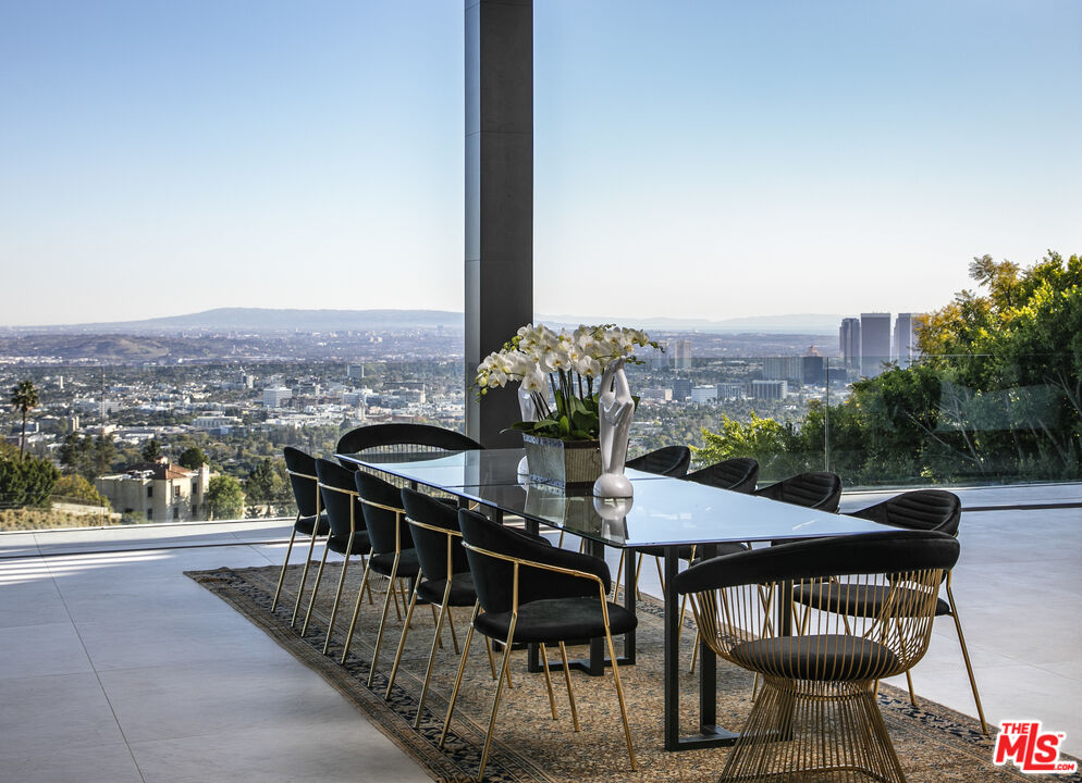 9364 Beverlycrest Drive Beverly Hills, CA 90210 - Photo 3 of 18 a view of a balcony dining table and chairs