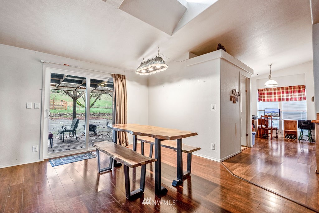 320 Sears Road Winlock, WA 98596 - Photo 12 of 26 a view of a dining room with furniture window and wooden floor
