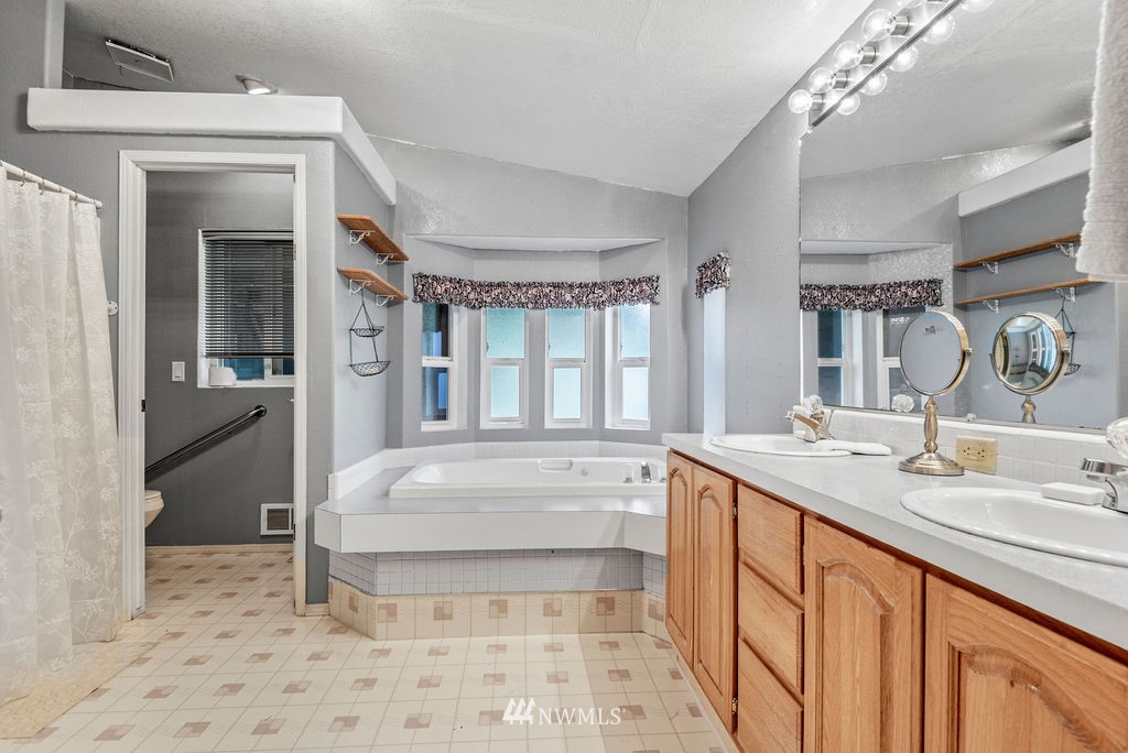 320 Sears Road Winlock, WA 98596 - Photo 16 of 26 a bathroom with a sink a large mirror and a shower