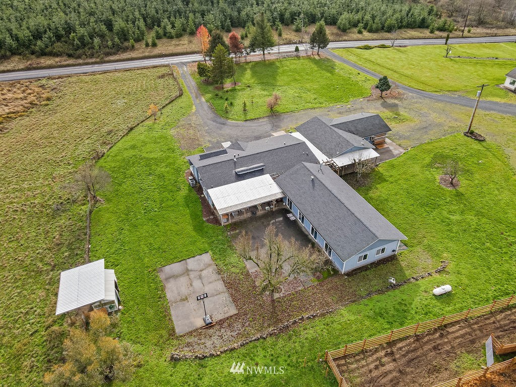 320 Sears Road Winlock, WA 98596 - Photo 26 of 26 an aerial view of a house with a garden and swimming pool