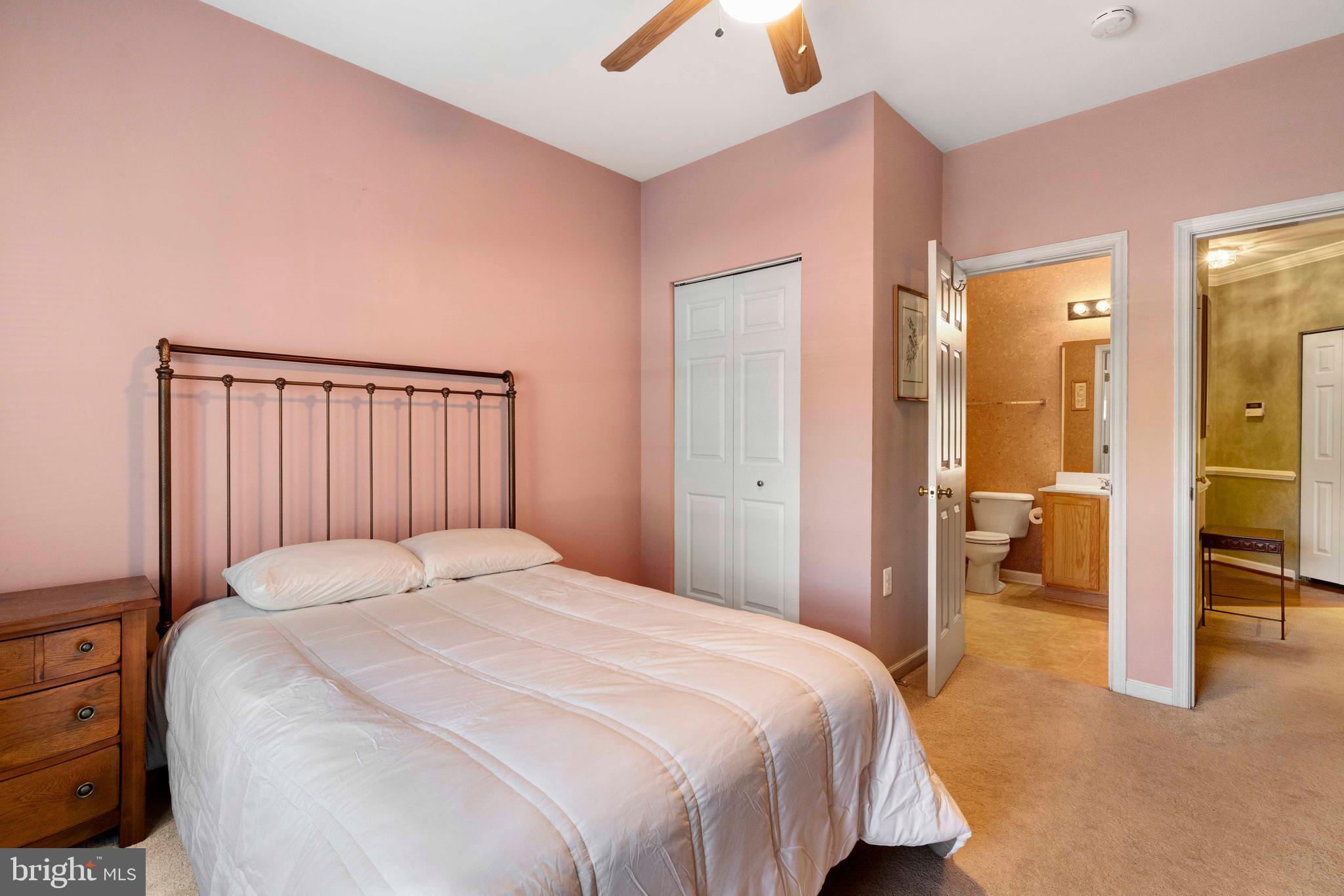 100 Fiddleleaf Lane, Unit 104 Warrington, PA 18976 - Photo 14 of 20 a bedroom with a large bed and a chandelier