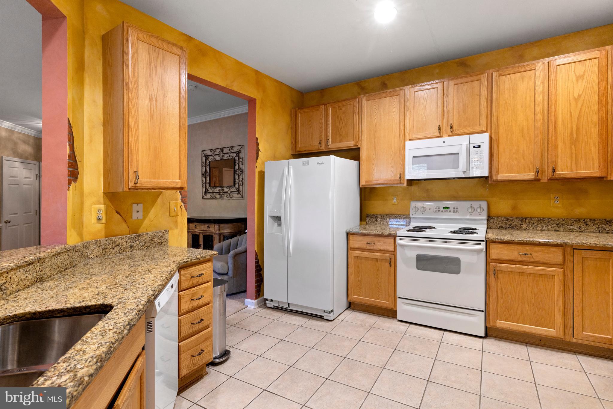 100 Fiddleleaf Lane, Unit 104 Warrington, PA 18976 - Photo 7 of 20 a kitchen with a stove a sink and a refrigerator