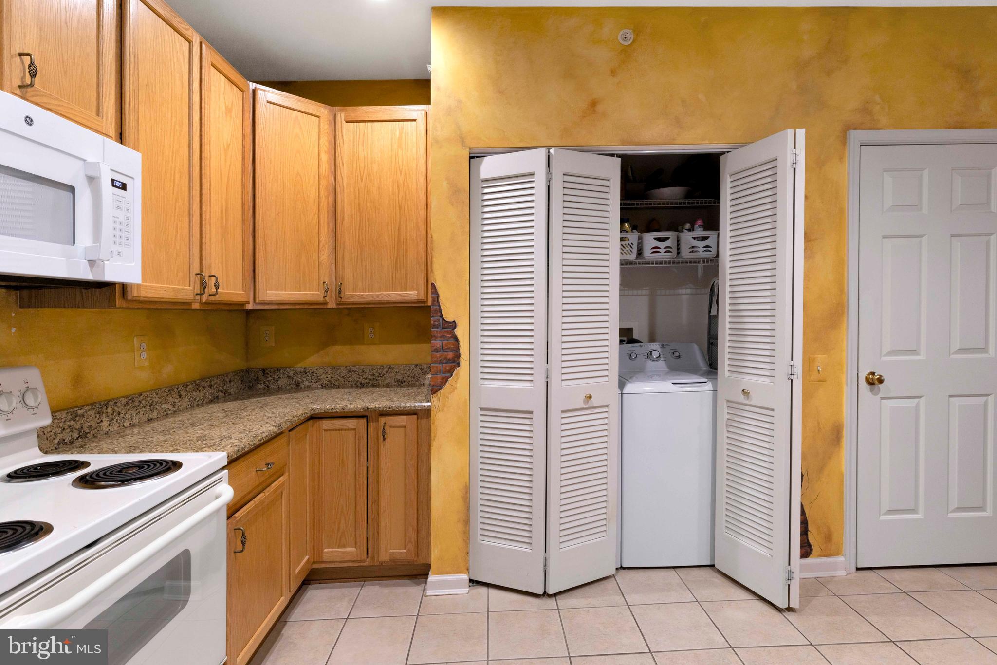 100 Fiddleleaf Lane, Unit 104 Warrington, PA 18976 - Photo 9 of 20 a kitchen with stainless steel appliances granite countertop a stove a sink and a refrigerator