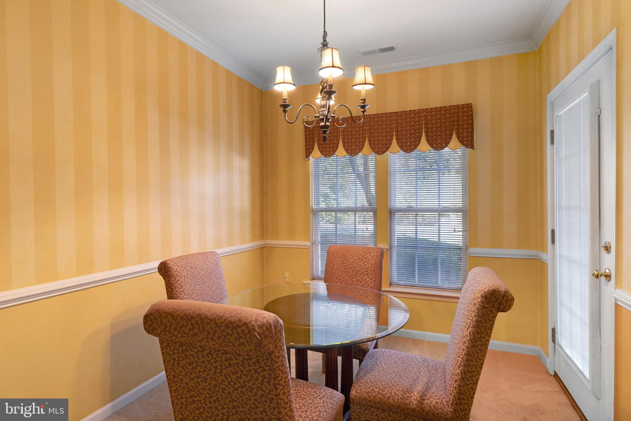 100 Fiddleleaf Lane, Unit 104 Warrington, PA 18976 - Photo 10 of 20 a view of a dining room with furniture and wooden floor