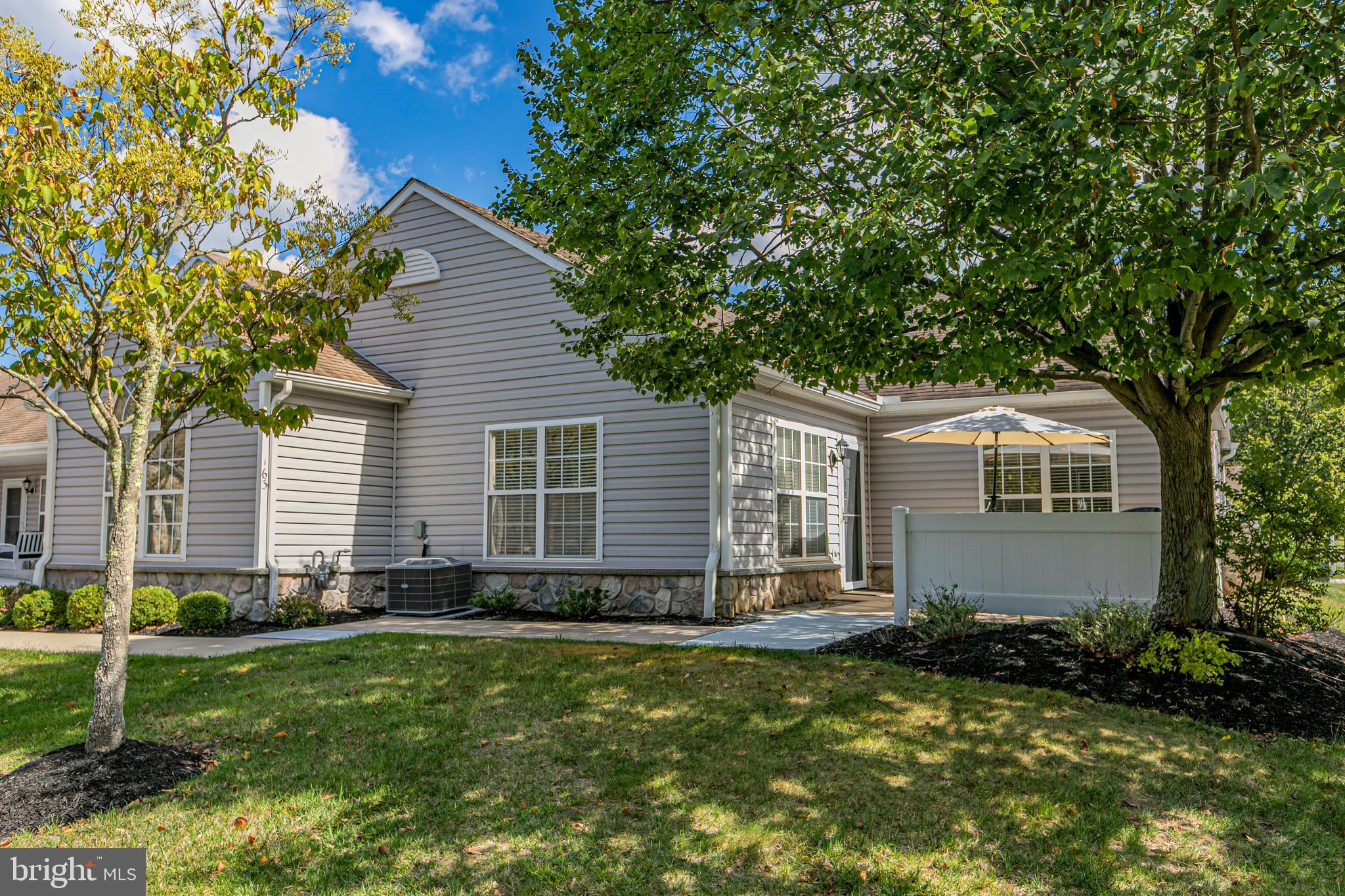 163 Federal Point Boulevard Lawrence Township, NJ 08648 - Photo 1 of 37 a front view of a house with a garden