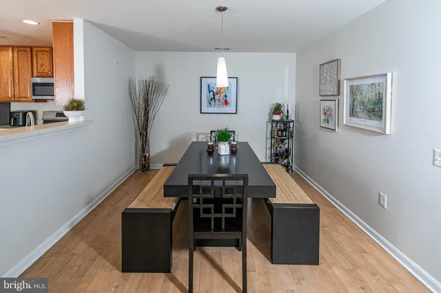 a view of a hallway with furniture and wooden floor