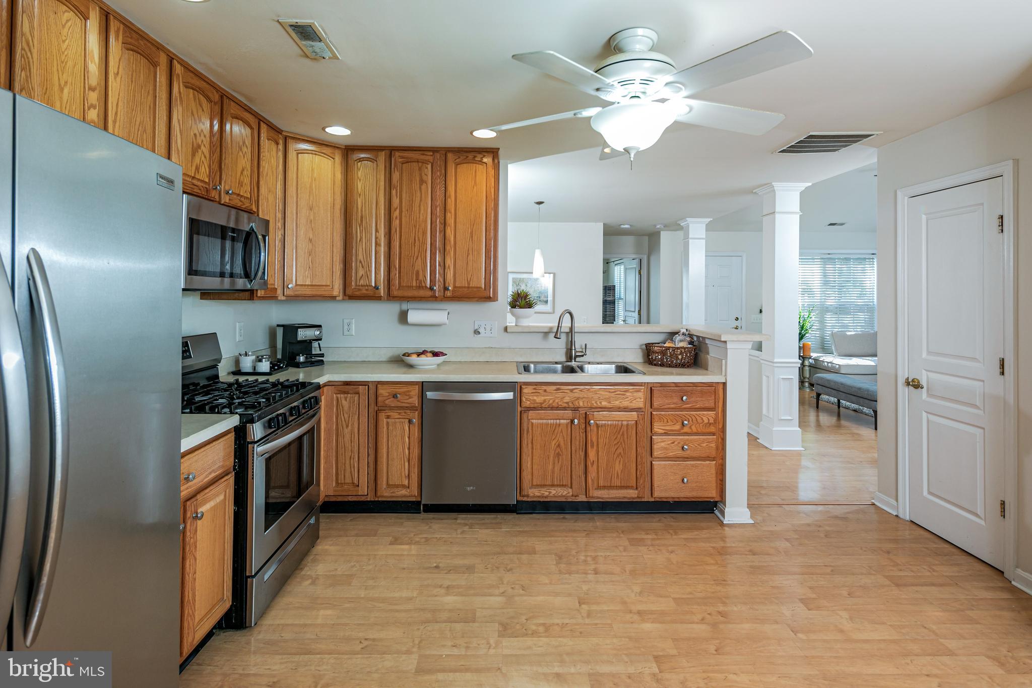 163 Federal Point Boulevard Lawrence Township, NJ 08648 - Photo 13 of 37 a kitchen with stainless steel appliances granite countertop a sink a stove a refrigerator cabinets and a dining table