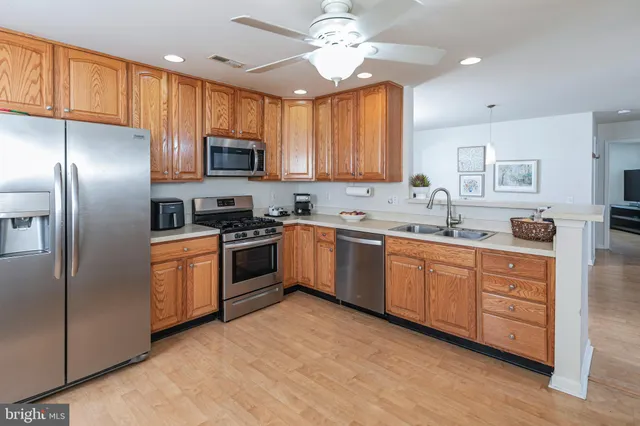 a kitchen with granite countertop a sink stainless steel appliances and counter space