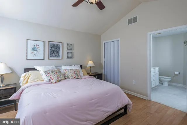 a bedroom with a bed and painting on the wall