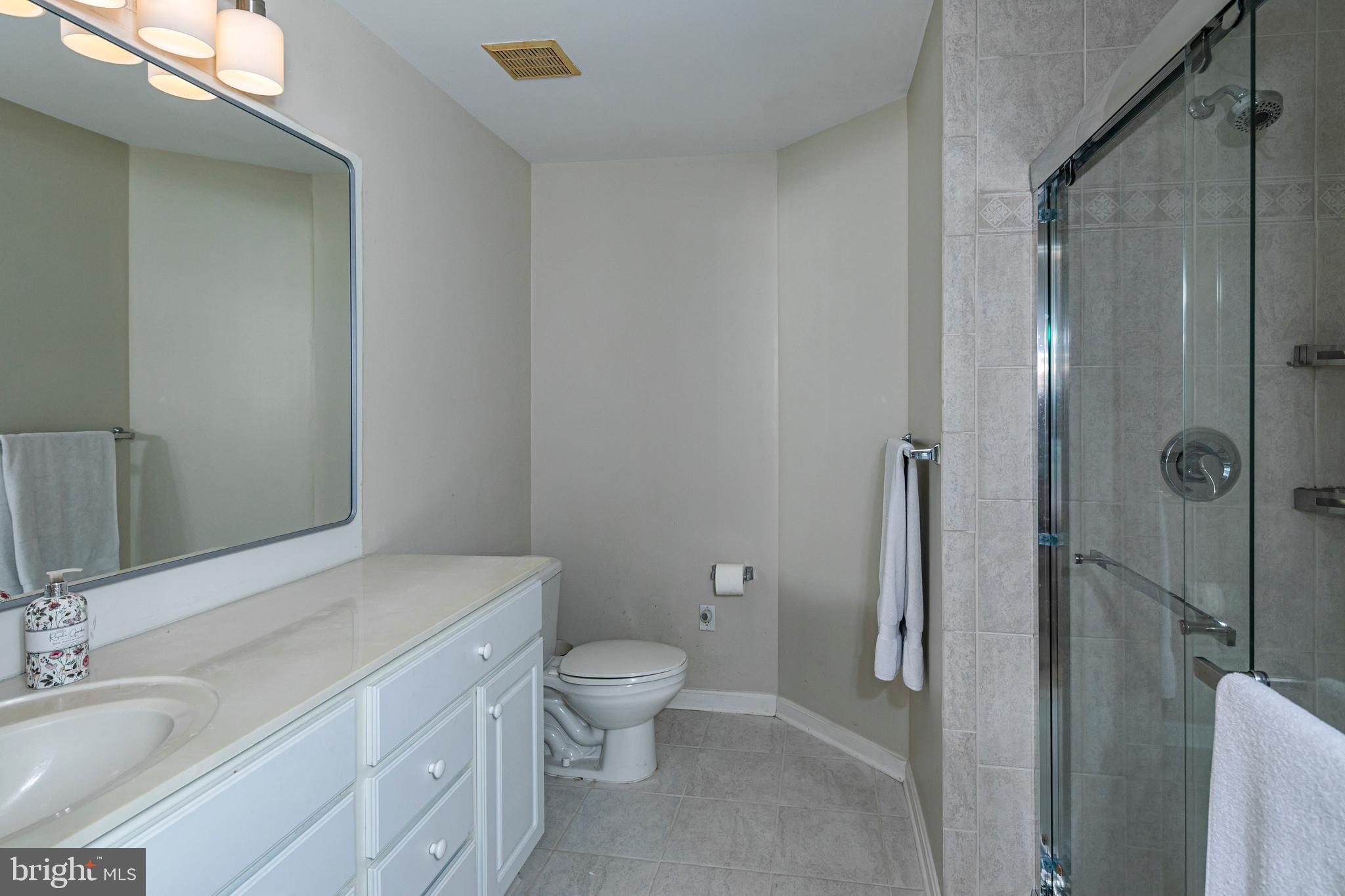 163 Federal Point Boulevard Lawrence Township, NJ 08648 - Photo 19 of 37 a bathroom with a granite countertop toilet a sink and a mirror