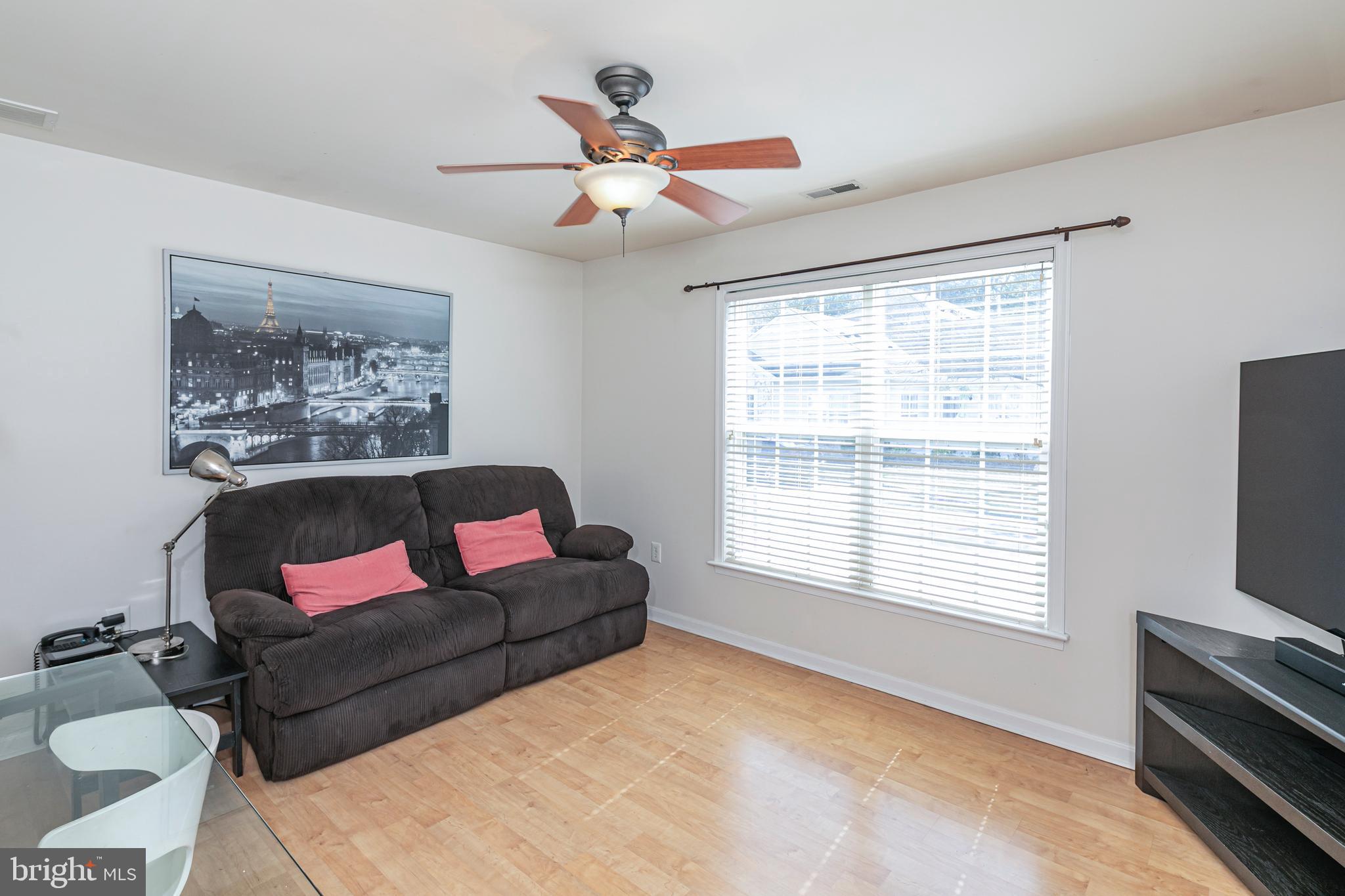 163 Federal Point Boulevard Lawrence Township, NJ 08648 - Photo 22 of 37 a living room with furniture a flat screen tv and a window