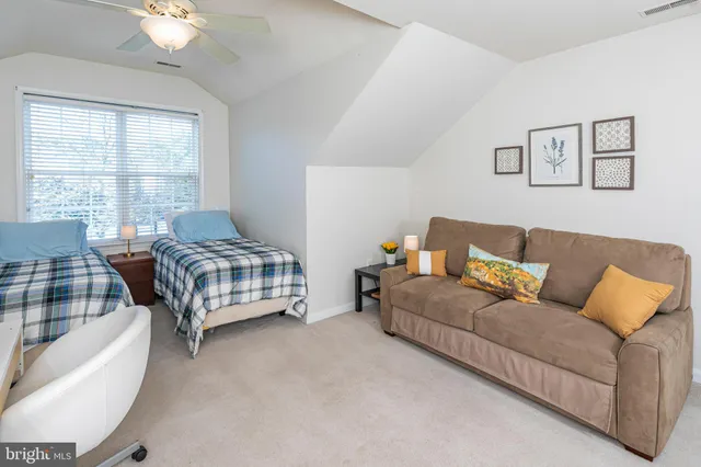 a bedroom with furniture and a large window