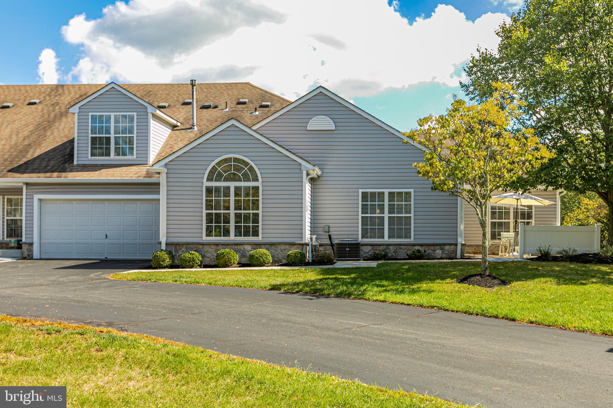 163 Federal Point Boulevard Lawrence Township, NJ 08648 - Photo 3 of 37 a front view of a house with a yard and garage