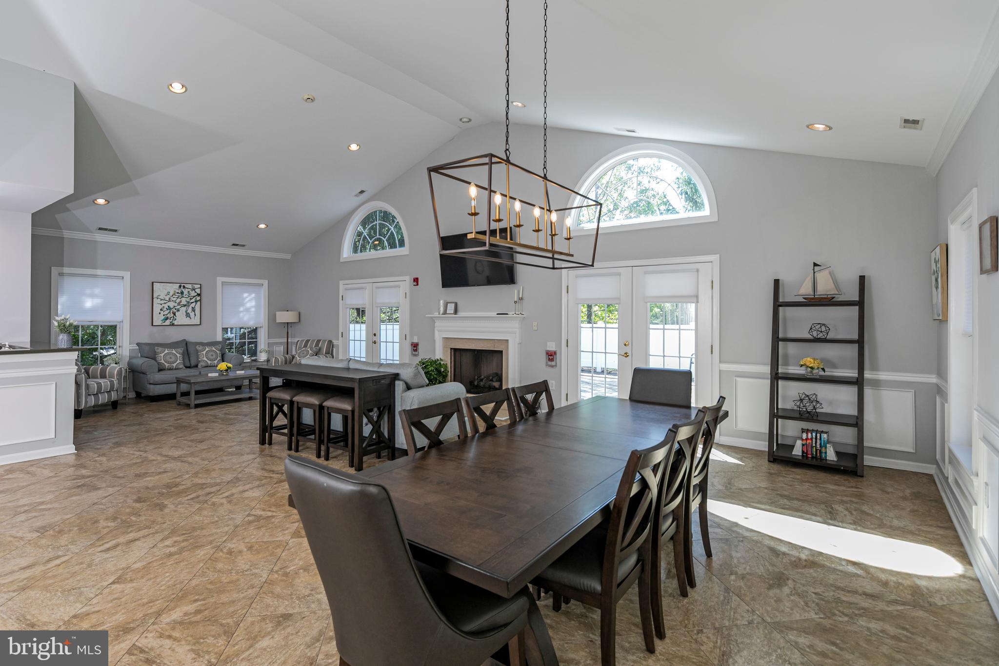 163 Federal Point Boulevard Lawrence Township, NJ 08648 - Photo 31 of 37 a dining room with wooden floor a chandelier a wooden table and chairs
