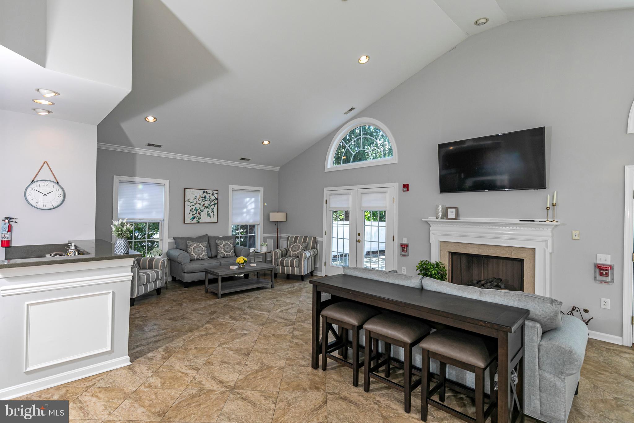 163 Federal Point Boulevard Lawrence Township, NJ 08648 - Photo 33 of 37 a living room with furniture a fireplace and a flat screen tv