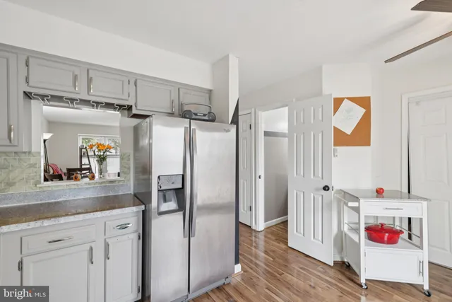 a very nice looking room with a kitchen island wooden floor and a window