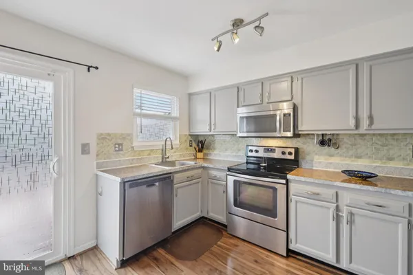 a very nice looking room with a kitchen island wooden floor and a window
