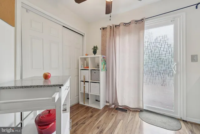 a view of entryway and hall with wooden floor