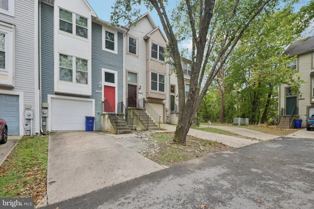 a view of a house with a tree in front