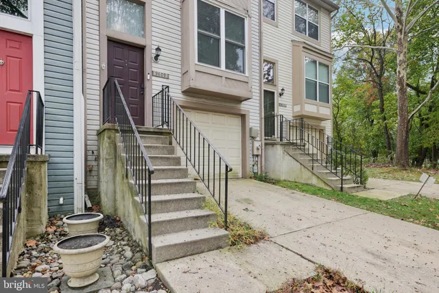 a view of a patio with table and chairs and wooden fence