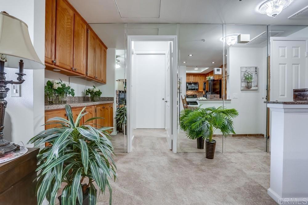 5875 Friars Road, Unit 4404 San Diego, CA 92110 - Photo 12 of 32 a view of a hallway with potted plants