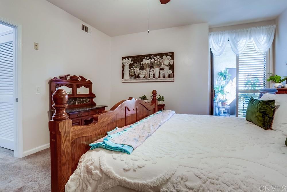 5875 Friars Road, Unit 4404 San Diego, CA 92110 - Photo 14 of 32 a bed sitting in a bedroom next to a window