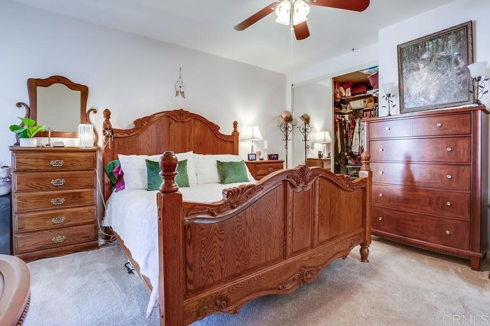 5875 Friars Road, Unit 4404 San Diego, CA 92110 - Photo 15 of 32 a bed room with a bed and a dresser