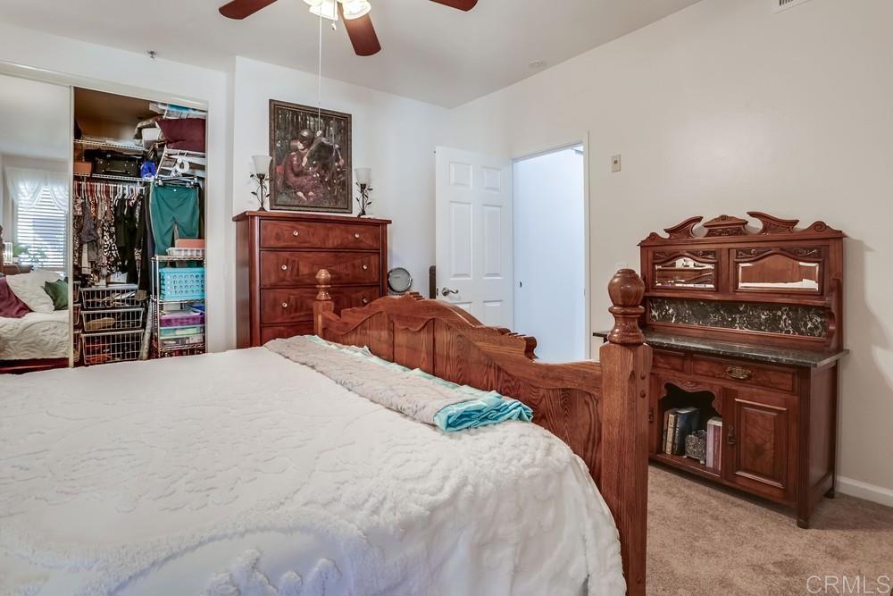 5875 Friars Road, Unit 4404 San Diego, CA 92110 - Photo 16 of 32 a bedroom with a bed and a television