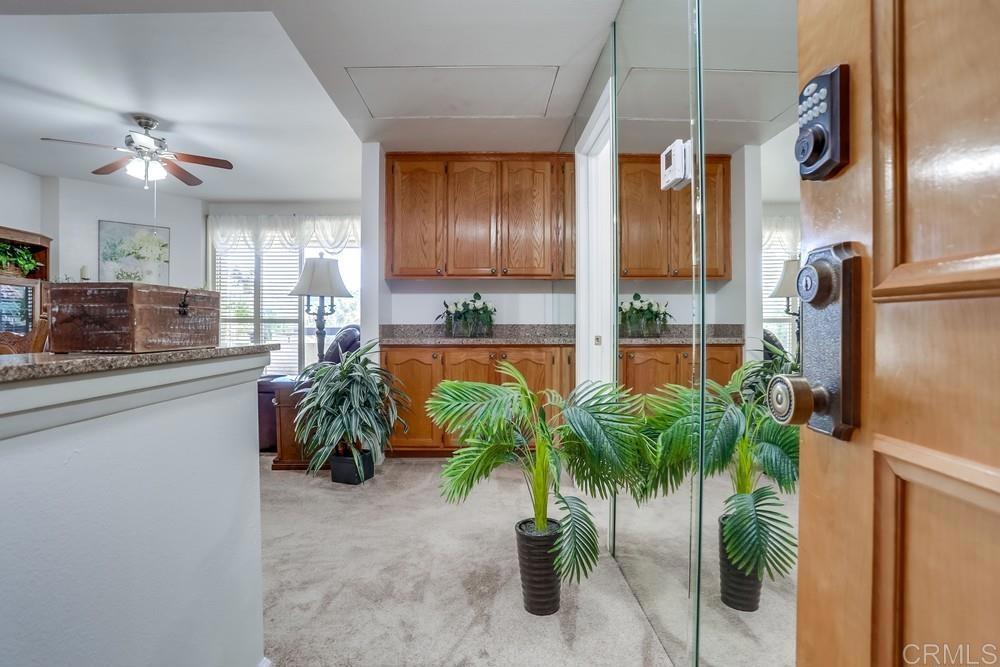 5875 Friars Road, Unit 4404 San Diego, CA 92110 - Photo 17 of 32 a kitchen with counter top and stainless steel appliances