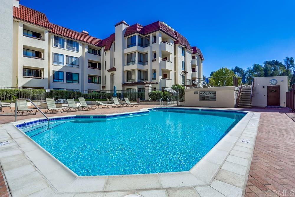 5875 Friars Road, Unit 4404 San Diego, CA 92110 - Photo 23 of 32 a large pool with outdoor seating