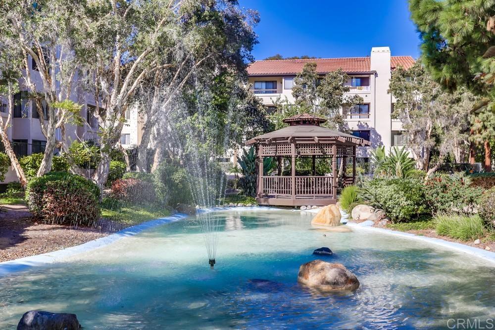 5875 Friars Road, Unit 4404 San Diego, CA 92110 - Photo 29 of 32 a view of a patio with table and chairs under an umbrella