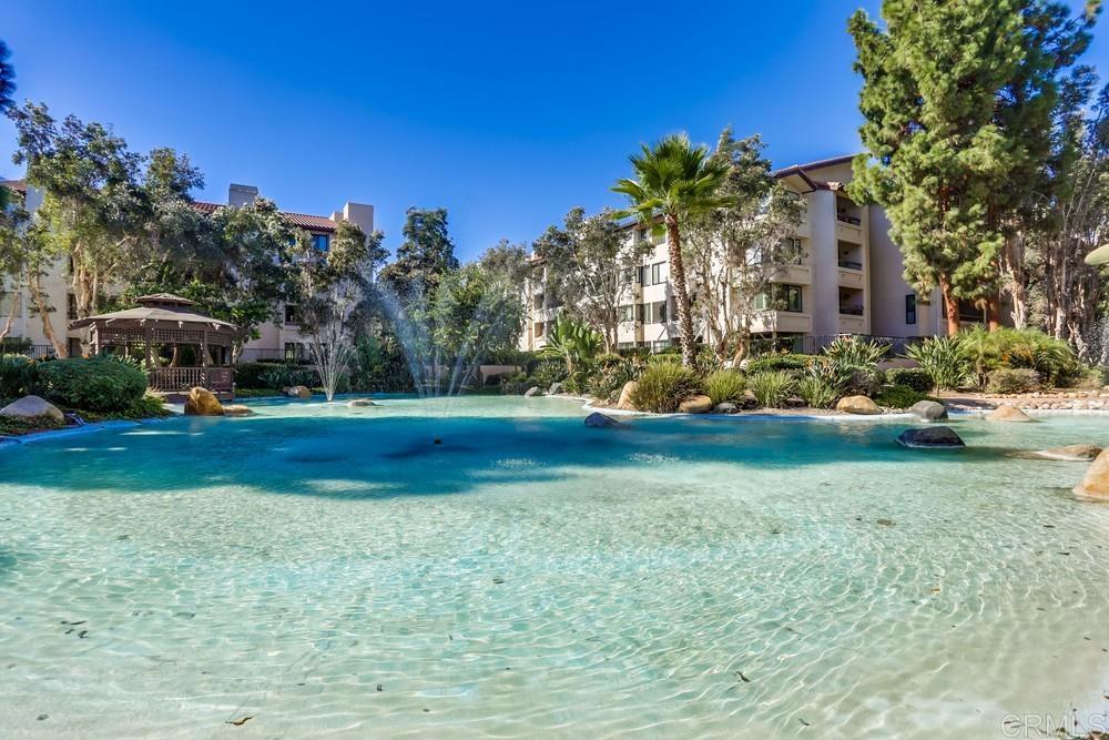 5875 Friars Road, Unit 4404 San Diego, CA 92110 - Photo 30 of 32 a view of a house with a big yard and large trees