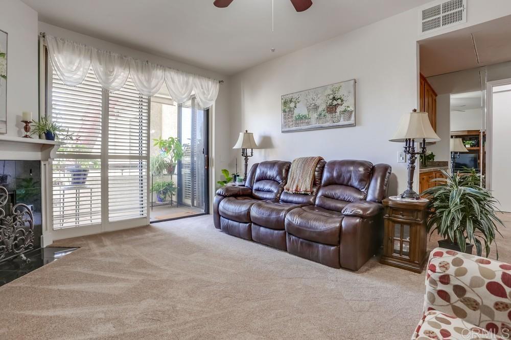 5875 Friars Road, Unit 4404 San Diego, CA 92110 - Photo 4 of 32 a living room with furniture and a fireplace