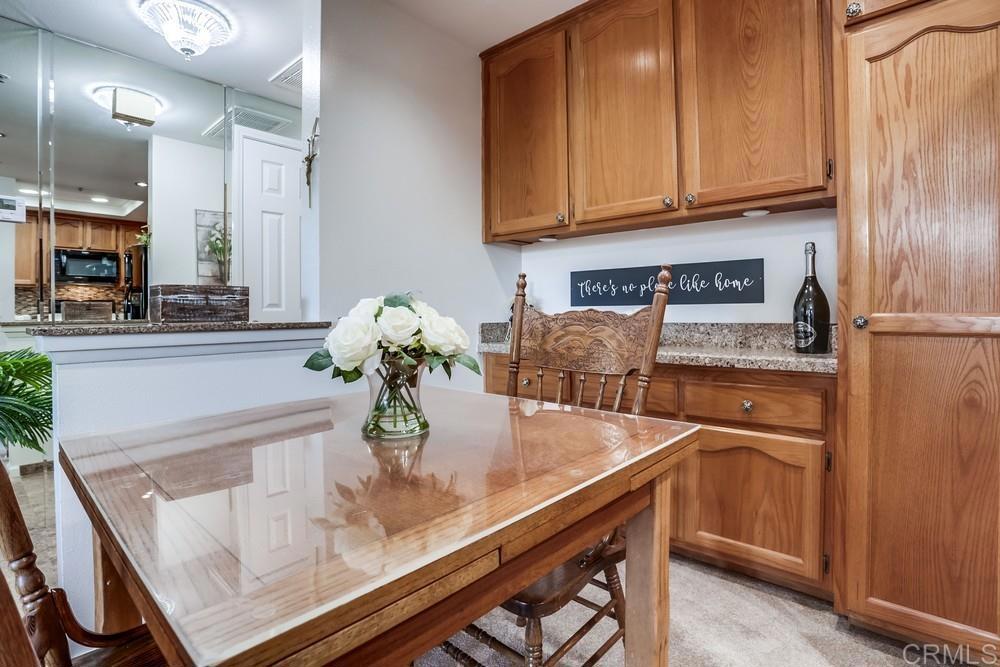 5875 Friars Road, Unit 4404 San Diego, CA 92110 - Photo 8 of 32 a kitchen with stainless steel appliances granite countertop a sink and a refrigerator