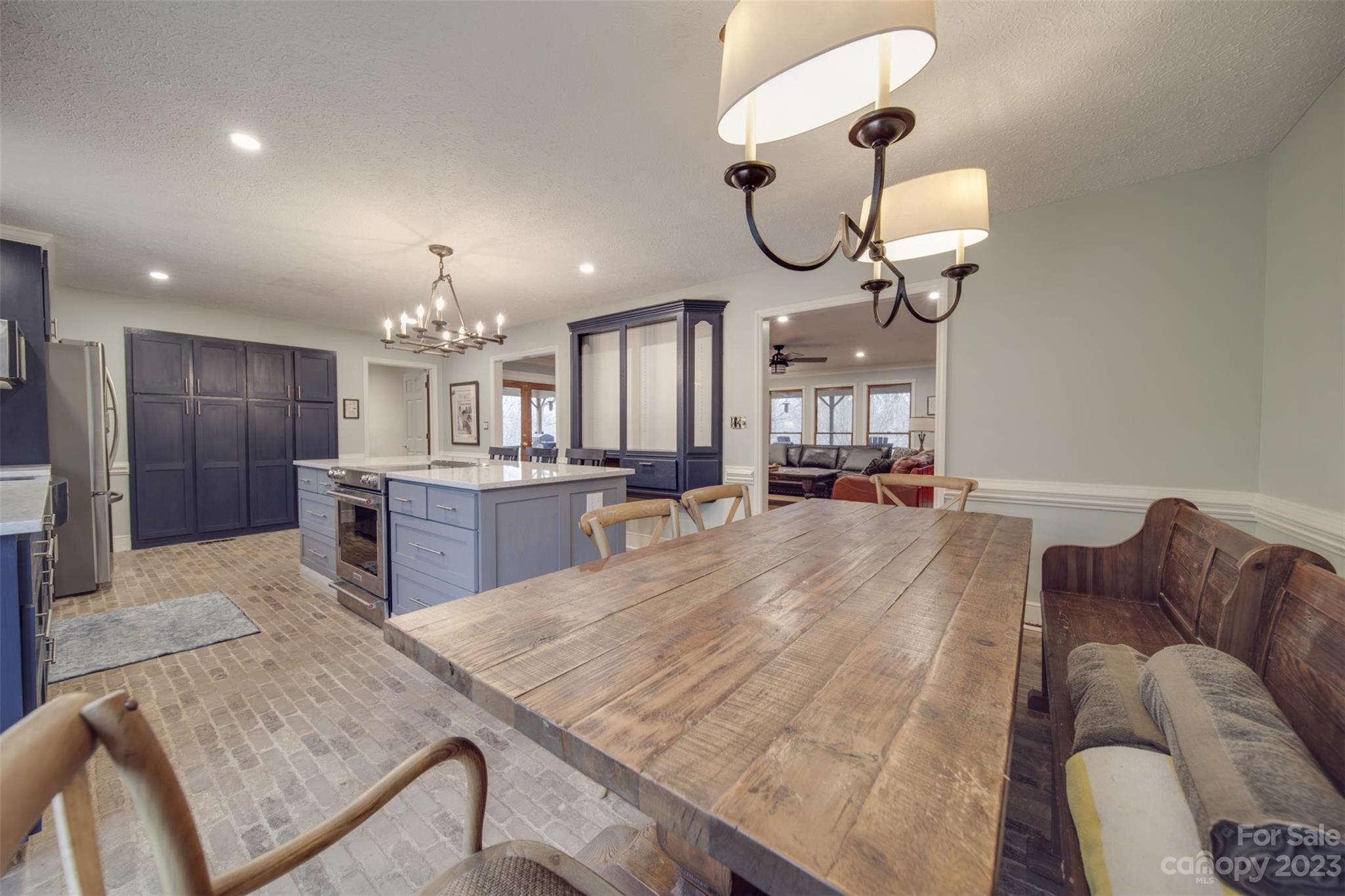 2699 Sharon Road York, SC 29745 - Photo 9 of 36 a living room with kitchen island furniture and a chandelier