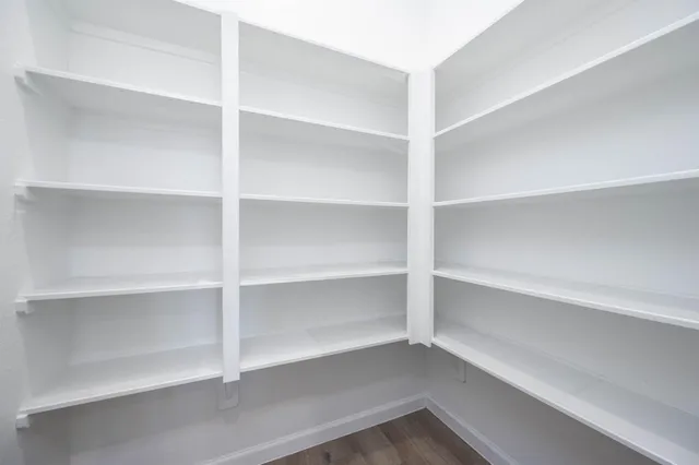 a view of walk in closet with empty racks